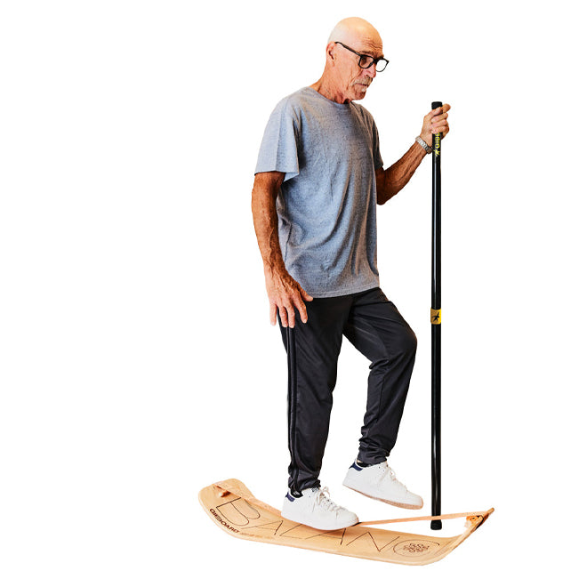 Elderly man on SlackBoard using a GIBBON Balance Pole