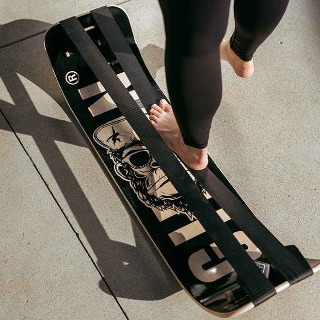 Person stepping onto a Caesar SlackBoard on a concrete surface.