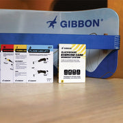Gibbon Slackboard and workout cards on a wooden surface