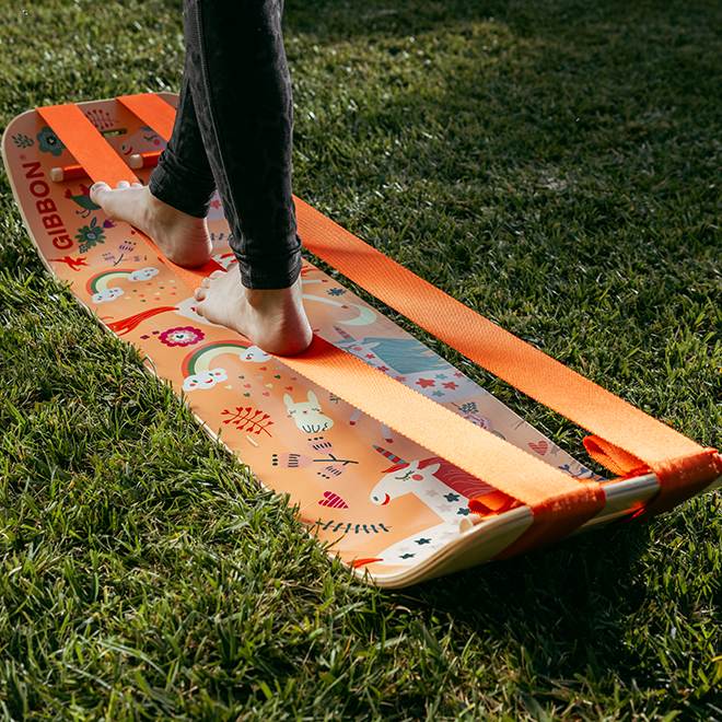 Person stepping onto an unicorn slackboard plus on grass