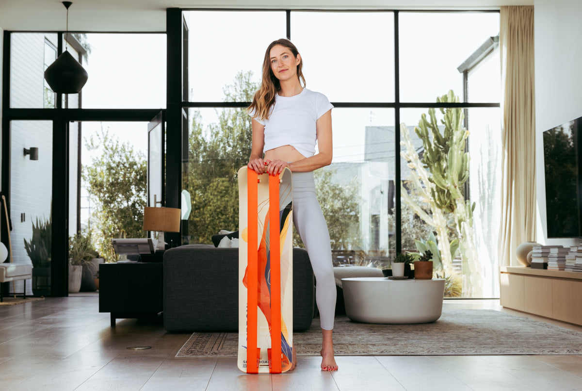 Woman standing with a Sunrise SlackBoard Plus at home